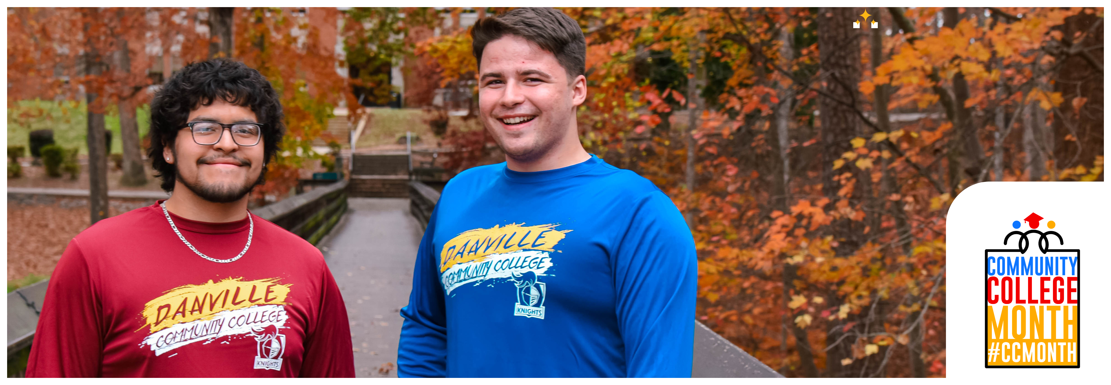 Two Danville Community College students stand outdoors on a campus walkway surrounded by fall foliage, promoting Community College Month.