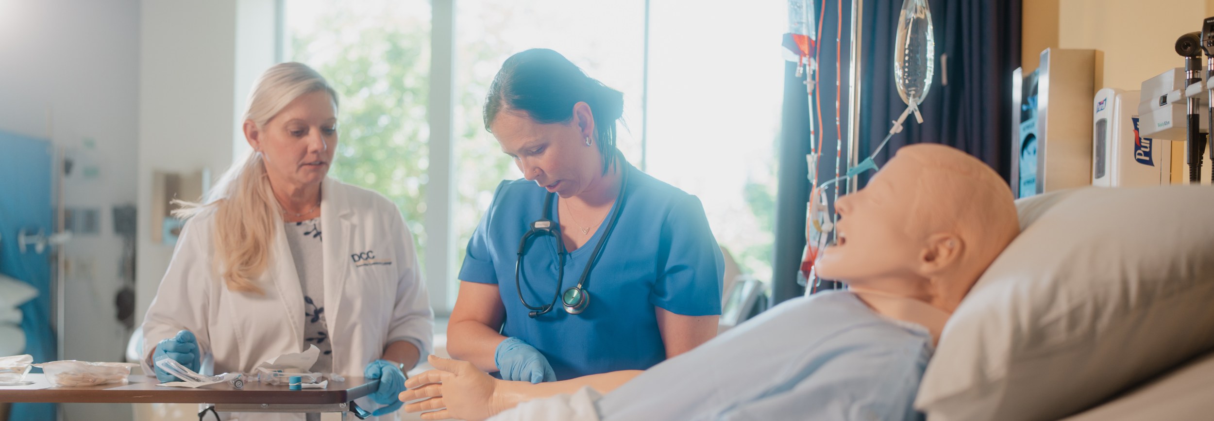 Two nursing students practicing.